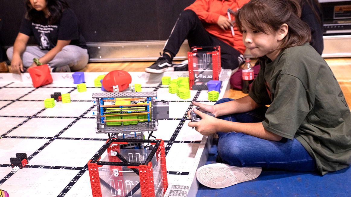 Participant controls VEX IQ Robot at Native American Showcase