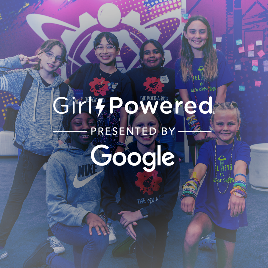 Girl Powered team poses in front of a Girl Powered Banner at VEX Robotics World Championship