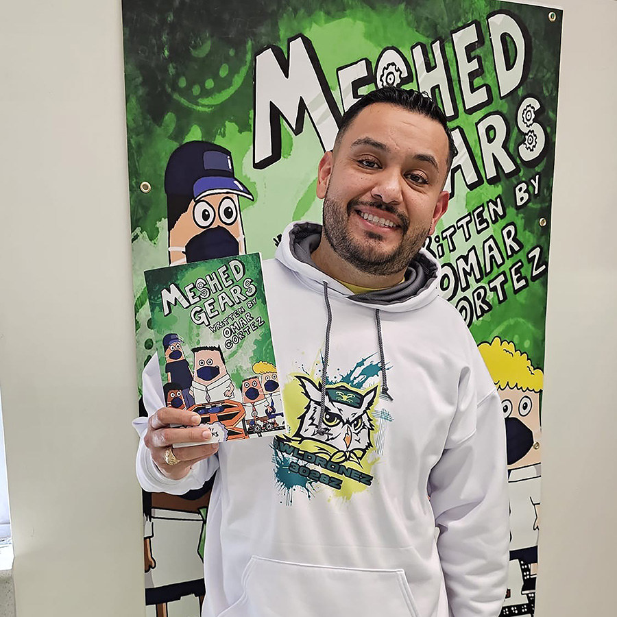 Omar shows his book, Mashed Gears