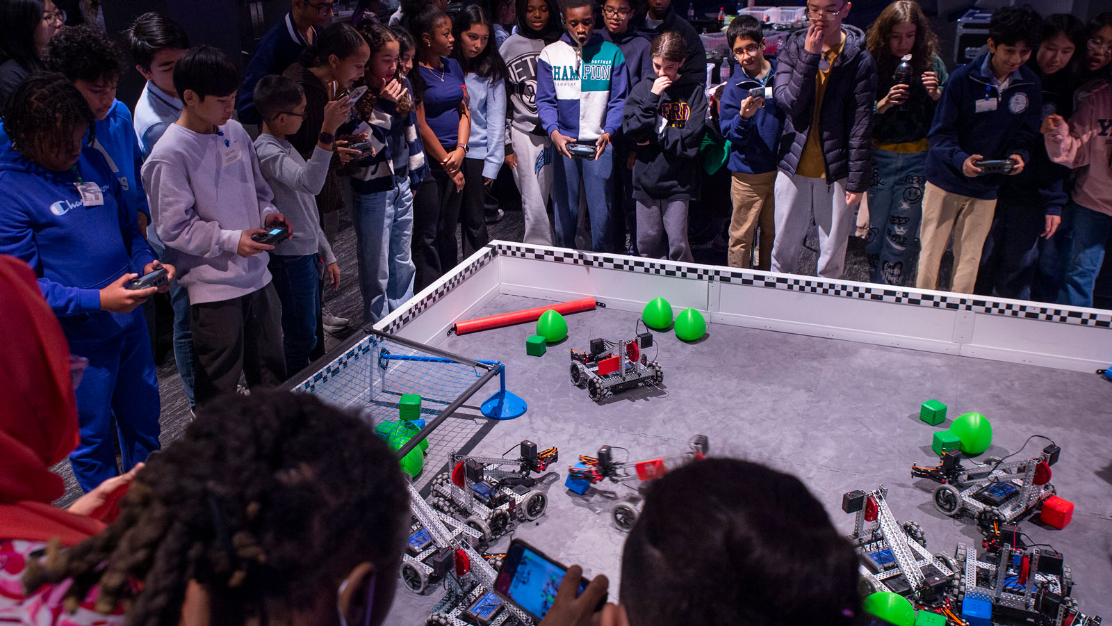 Teams drive robots on a field at Prep for Prep