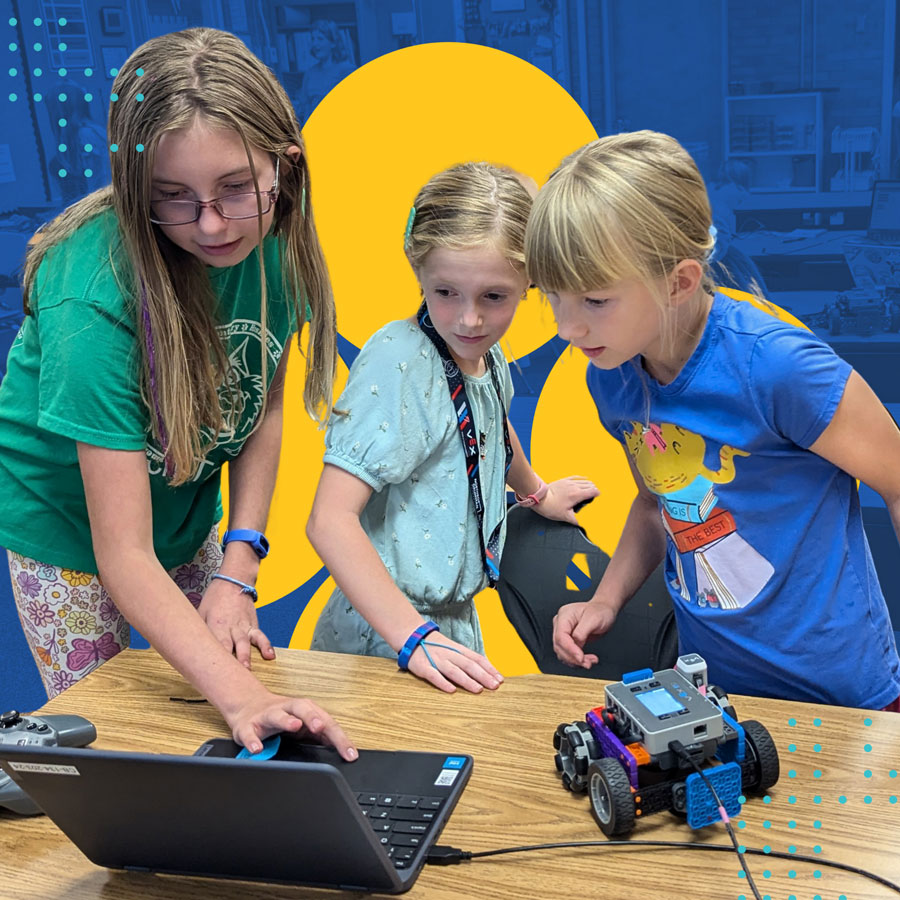 Team works on a robot at a computer