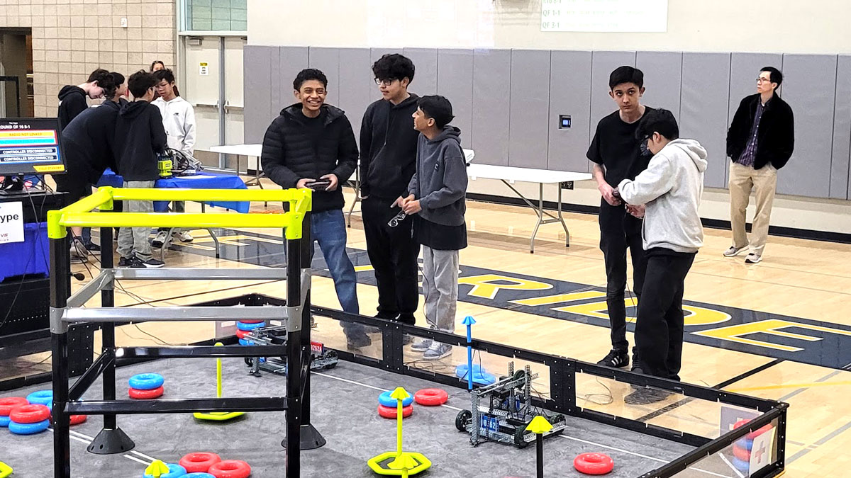 Teams 90262A and 90262E compete at a VEX V5 Robotics Competition event.