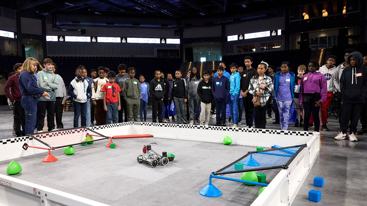 Participants gather around a field at a Google Data Centers Robotics for Kids Program event.