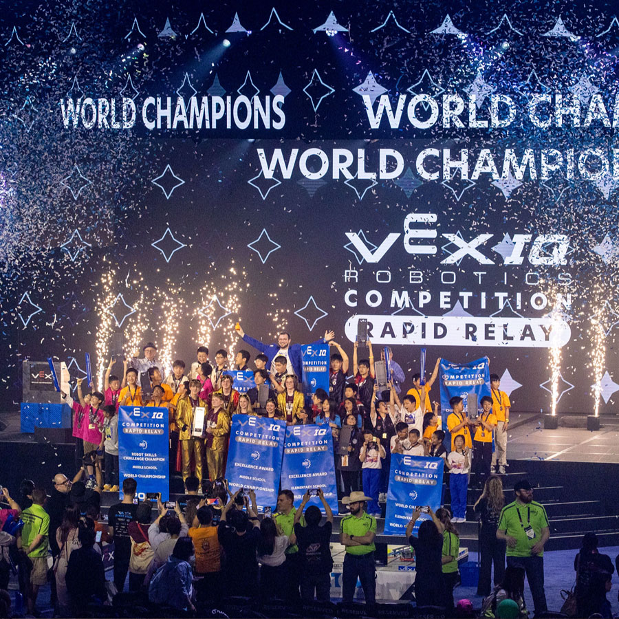 Championship VEX IQ Robotics Competition teams celebrate on stage at VEX Robotics World Championship