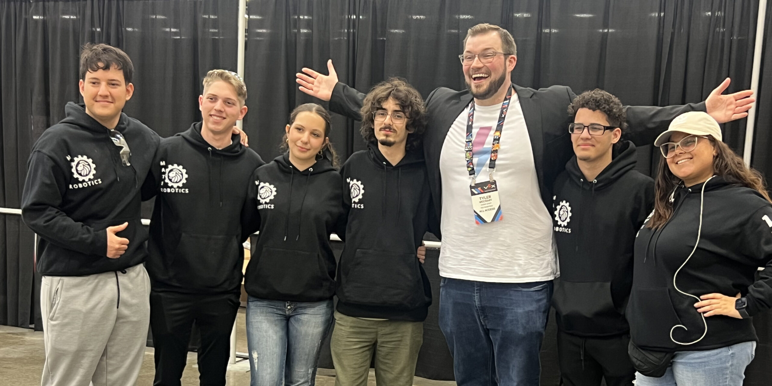 VEX Robotics World Championship host Tyler McCrary poses with a team