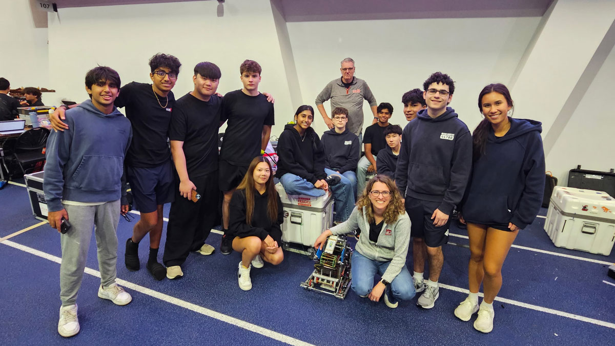 Robotics coach Bill McDonough with his students