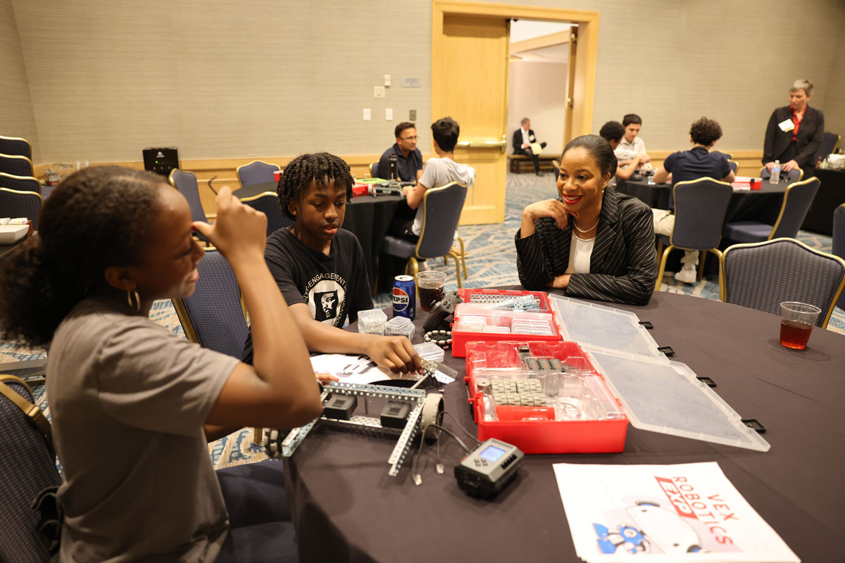 Chandra Donelson works with students as they build a robot.