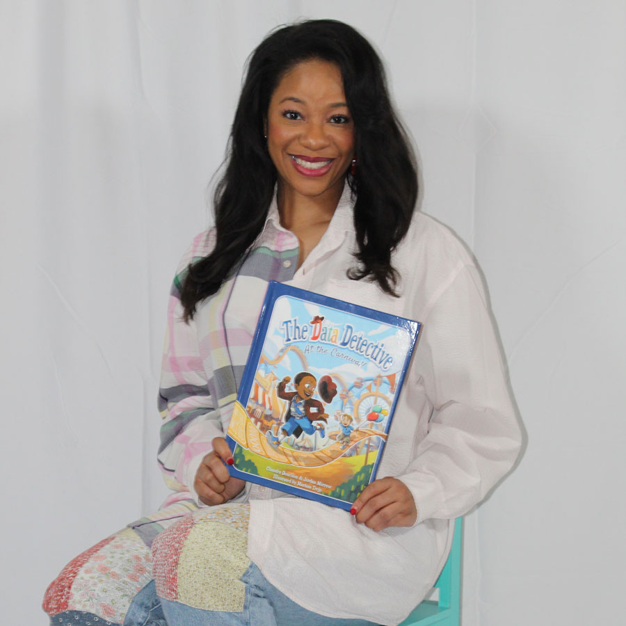 Chandra Donelson holds the book she co-wrote, 
