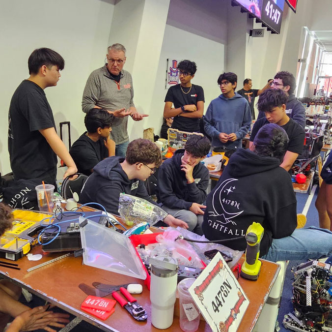 Robotics coach Bill McDonough teaches his students